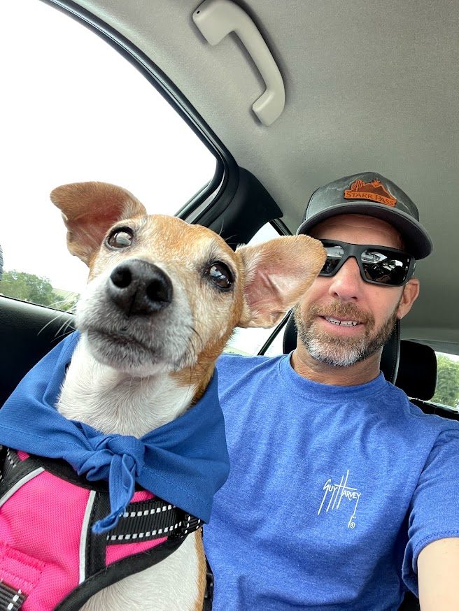 Paris in a blue bandana riding shotgun with Mathew