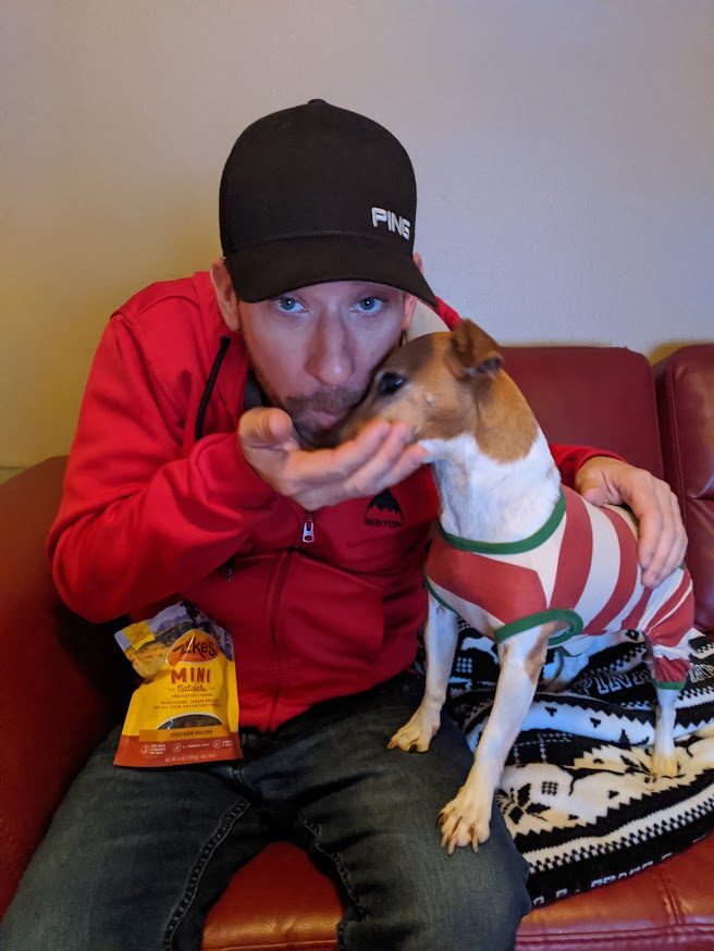 Mathew feeding Paris a treat on the couch at Christmas