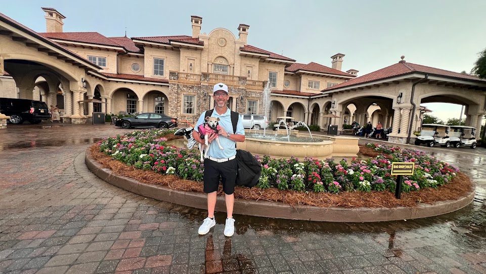 Mathew holding Paris outside a clubhouse